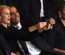 US President Barack Obama (right) and British Prime Minister David Cameron pose for a picture with Denmark's Prime Minister Helle Thorning Schmidt (center) next to US First Lady Michelle Obama during the memorial service of South African former president Nelson Mandela at the FNB Stadium (Soccer City) in Johannesburg on Tuesday, December 10, 2013.  AFP FILE PHOTO