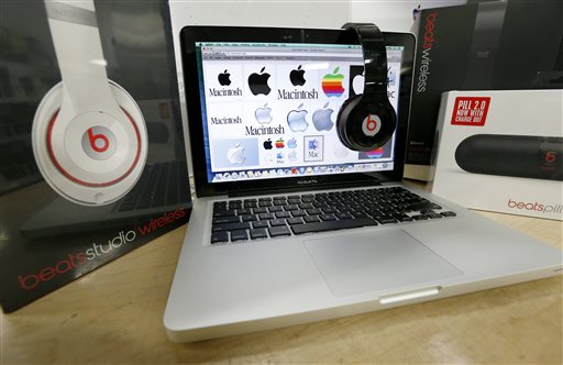 Beats Audio equipment is arranged for a photo next to an Apple laptop at Best Buy in Boston, Friday, May 9, 2014. Apple is orchestrating a $3.2 billion acquisition of Beats Electronics, the headphone maker and music streaming distributor founded by hip-hop star Dr. Dre and record producer Jimmy Iovine, according to a Financial Times report published late Thursday, May 8, 2014. AP