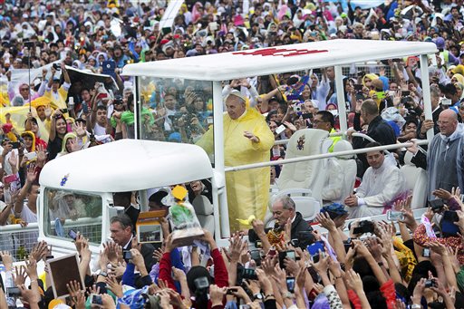 Pope Francis waves to the crowd as he arrives at Quirino Grandstand to celebrate his final Papal Mass in Manila, Philippines, Sunday, Jan. 18, 2015. AP