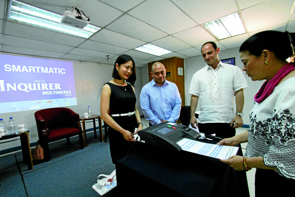 VOTING DEMO INQUIRER president and CEO Sandy Prieto-Romualdez casts her vote during a demo of Smartmatic’s vote-countingmachine (VCM) for the Meet Inquirer Multimedia Forum in Makati City on Friday.With them are (from left) Smartmatic’s head for voter education Karen Jimeno, general manager Elie Moreno and sales technical coordinatorMiguel Avila. RICHARD A. REYES