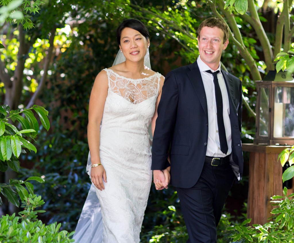 This photo provided by Facebook shows Facebook founder and CEO Mark Zuckerberg and Priscilla Chan at their wedding ceremony in Palo Alto, Calif., Saturday, May 19, 2012. Zuckerberg updated his status to "married" on Saturday. The ceremony took place in Zuckerberg's backyard before fewer than 100 guests, who all thought they were there to celebrate Chan's graduation.  AP PHOTO/FACEBOOK, ALLYSON MAGDA PHOTOGRAPHY