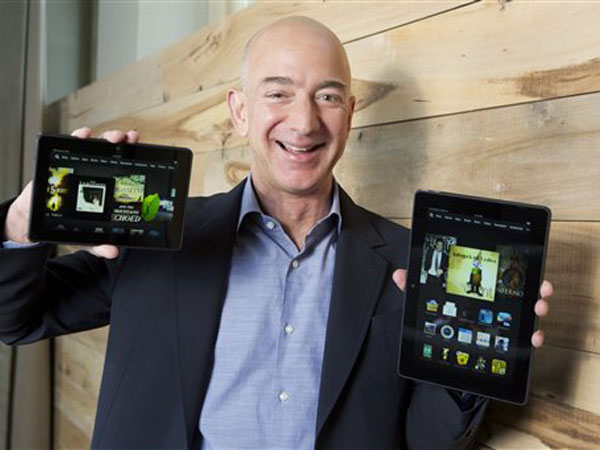 In this image distributed on Tuesday, Sept. 24, 2013, Amazon.com Founder and CEO Jeff Bezos introduces the all-new Kindle Fire HDX 8.9'', right, and Kindle Fire HDX 7'' tablet in Seattle." AP