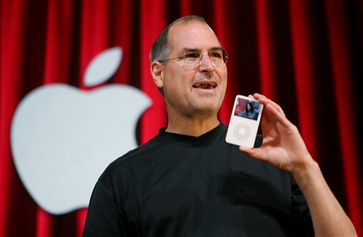  In this Oct. 12, 2005 file photo, Apple Computer Inc. CEO Steve Jobs holds up an iPod during an event in San Jose, Calif. Jurors in a class-action lawsuit against Apple Inc. on Tuesday, Dec. 2, 2014 saw emails from the late CEO and his top lieutenants that show Jobs was determined to keep Apple's popular iPod music players free from songs that were sold by competing online stores. AP 