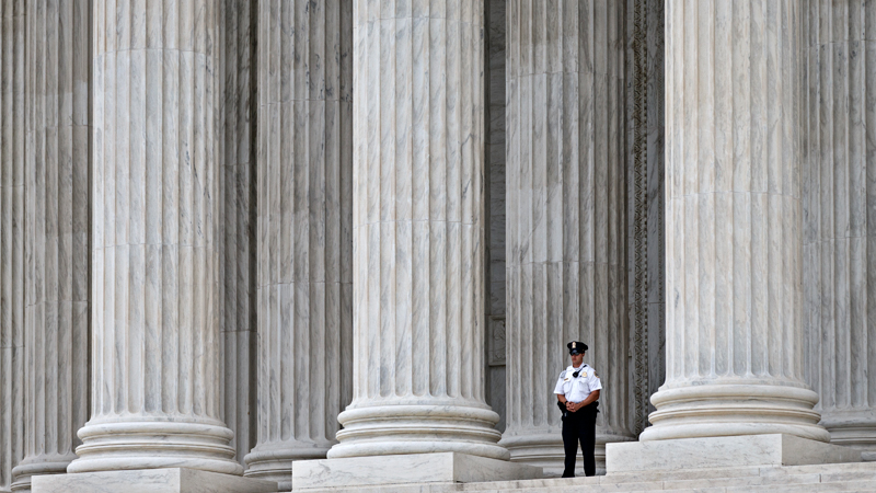  This Oct. 7, 2014, file photo shows a police officer dwarfed amid the marble columns of the U.S. Supreme Court in Washington. Anthony Elonis claimed he was just kidding when he posted a series of graphically violent rap lyrics on Facebook about killing his estranged wife, shooting up a kindergarten class and attacking an FBI agent. But his wife didn't see it that way. Neither did a federal jury. In a far-reaching case that probes the limits of free speech over the Internet, the Supreme Court on Monday is considering whether Elonis' Facebook posts, and others like it, deserve protection under the First Amendment. (AP Photo/J. Scott Applewhite, File)