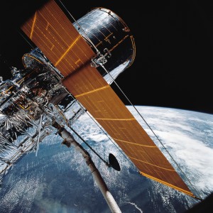 In this April 25, 1990 photograph provided by NASA, most of the giant Hubble Space Telescope can be seen as it is suspended in space by Discovery's Remote Manipulator System (RMS) following the deployment of part of its solar panels and antennae. This was among the first photos NASA released on April 30 from the five-day STS-31 mission.  The Hubble Space Telescope, one of NASA'S crowning glories, marks its 25th anniversary on Friday, April 24, 2015. With more than 1 million observations, including those of the farthest and oldest galaxies ever beholden by humanity, no man-made satellite has touched as many minds or hearts as Hubble.  (NASA via AP)