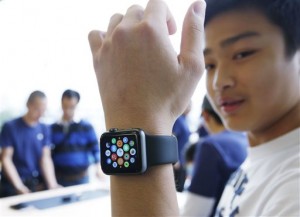 A customer tries on an Apple Watch at an Apple Store in Hong Kong Friday, April 10, 2015. AP Photo