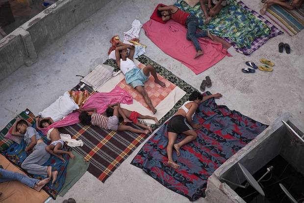 FILE - In this May 29, 2015 file photo, Indians sleep on the roof of a house to beat the heat in New Delhi, India. Even for a world getting used to wild weather, May seems stuck on strange. Torrential downpours in Texas, whiplashing the region from drought to flooding. A heatwave that has already killed more than 1800 in India and is the fifth deadliest since 1900. Record 91 degree temperature in of all places Alaska. A pair of top-of-the-scale typhoons in the Northwest Pacific.  And a drought in the U.S. East is starting to take root just as the one ends in Texas.  (AP Photo/Tsering Topgyal, File)