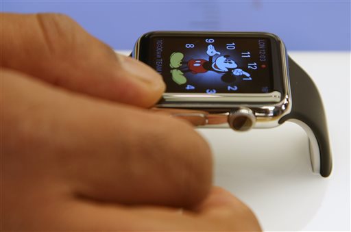 In this April 10, 2015 file photo, a customer handles an Apple Watch at an Apple store in Sydney. U.S. retailer Best Buy Co. says it will sell the Apple Watch at 100 of its stores and on its website beginning Aug. 7, 2015. AP FILE PHOTO