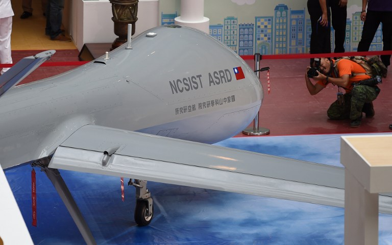A photographer takes photo of the latest home-made MALE Unmanned Aircraft Systems during a press conference of the 2015 Taipei Aerospace and Defense Technology Exhibition at the World Trade Center in Taipei on August 12, 2015. Taiwan will unveil the prototype of its largest military drone to the public at a Taipei convention, a chance for the island to flex its muscles in the face of China's growing military might. AFP PHOTO/SAM YEH