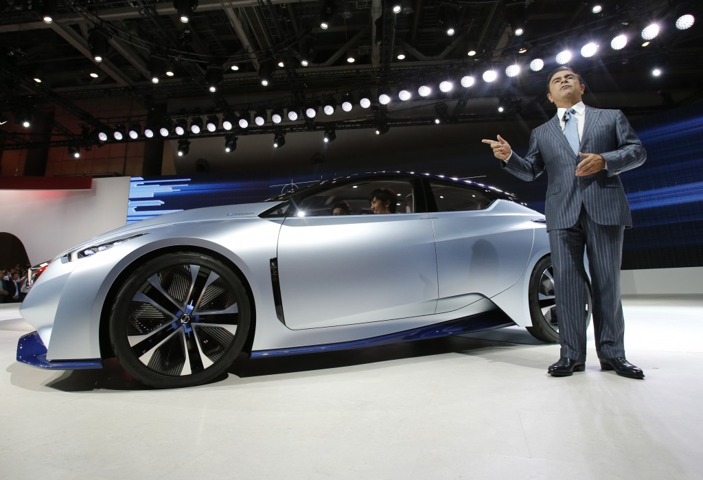 Carlos Ghosn, president and CEO of Nissan Motor Co., unveils the Nissan IDS Concept vehicle in the media preview for the Tokyo Motor Show in Tokyo, Wednesday, Oct. 28, 2015.  The biennial exhibition of vehicles in Japan runs for the public from Friday, Oct. 30.  (AP Photo/Shuji Kajiyama)