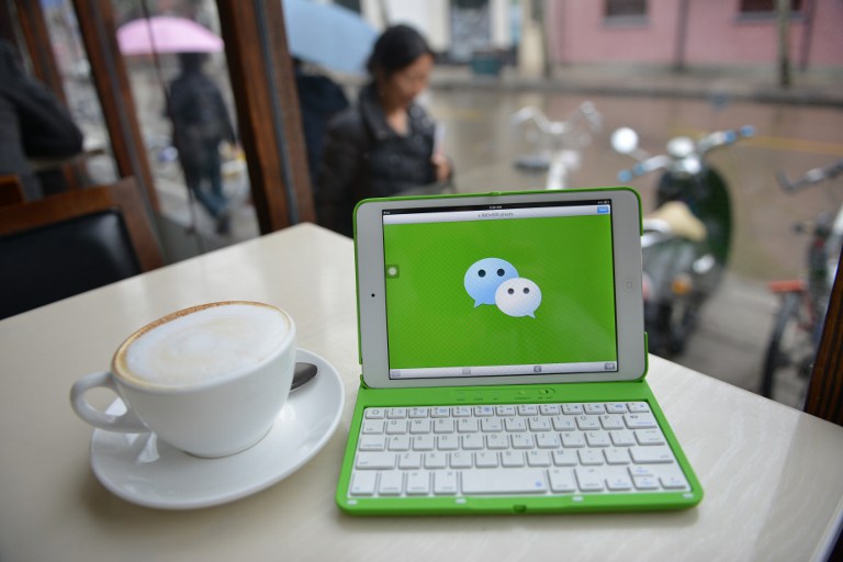 This photo illustration taken on March 12, 2014 shows the logo of Chinese instant messaging platform called WeChat on a mobile device which has taken the country by storm in just three years. WeChat has taken China by storm in just three years, allowing its more than 300 million users to send text, photos, videos and voice messages over smartphones, find each other by shaking their devices -- a common dating technique -- and even book and pay for taxis. AFP PHOTO/Peter PARKS / AFP / PETER PARKS