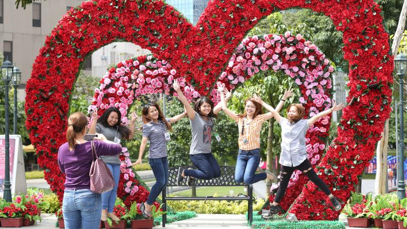 CONFIDENTLY POSING, WITH A HEART Young women strike a wacky pose under a heart-shaped arch made of roses set up at Bonifacio Global City in Taguig in time for Valentine’s Day. MARIANNE BERMUDEZ