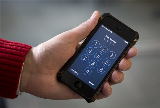 An iPhone is seen in Washington, Wednesday, Feb. 17, 2016. A U.S. magistrate judge has ordered Apple to help the FBI break into a work-issued iPhone used by one of the two gunmen in the mass shooting in San Bernardino, California, a significant legal victory for the Justice Department in an ongoing policy battle between digital privacy and national security. Apple CEO Tim Cook immediately objected, setting the stage for a high-stakes legal fight between Silicon Valley and the federal government. AP PHOTO
