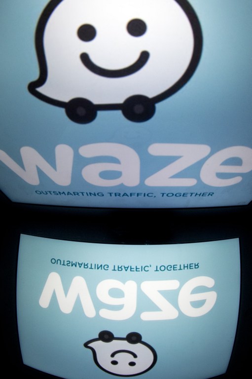 The logo of mobile app "Waze" is displayed on a tablet on January 2, 2014 in Paris. Waze is a community-based traffic and navigation app.  AFP 