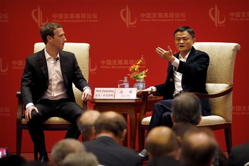Facebook CEO Mark Zuckerberg, left, listens as Jack Ma, executive chairman of the Alibaba Group, speaks during a panel discussion held as part of the China Development Forum at the Diaoyutai State Guesthouse in Beijing, Saturday, March 19, 2016. AP PHOTO
