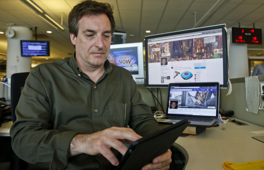 In this May 13, 2016, photo, Peter Costanzo is shown at the Associated Press headquarters where he is the digital and archival manager in New York. Costanzo is the man who helped turn Donald Trump into @RealDonaldTrump. That, of course, is Trump’s Twitter account, a centerpiece of the presumptive Republican nominee’s presidential campaign and his vehicle of choice for pumping out political attacks and self-promotion to more than 8 million followers. (AP Photo/Bebeto Matthews)