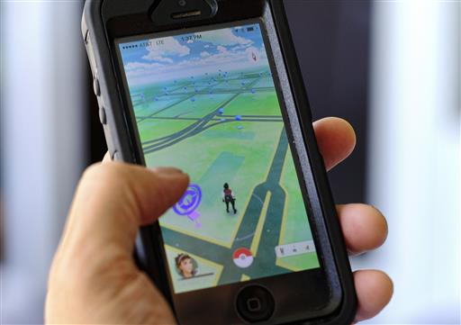 Pokemon Go is displayed on a cell phone in Los Angeles on Friday, July 8, 2016. Just days after being made available in the U.S., the mobile game Pokemon Go has jumped to become the top-grossing app in the App Store. And players have reported wiping out in a variety of ways as they wander the real world, eyes glued to their smartphone screens, in search of digital monsters. AP