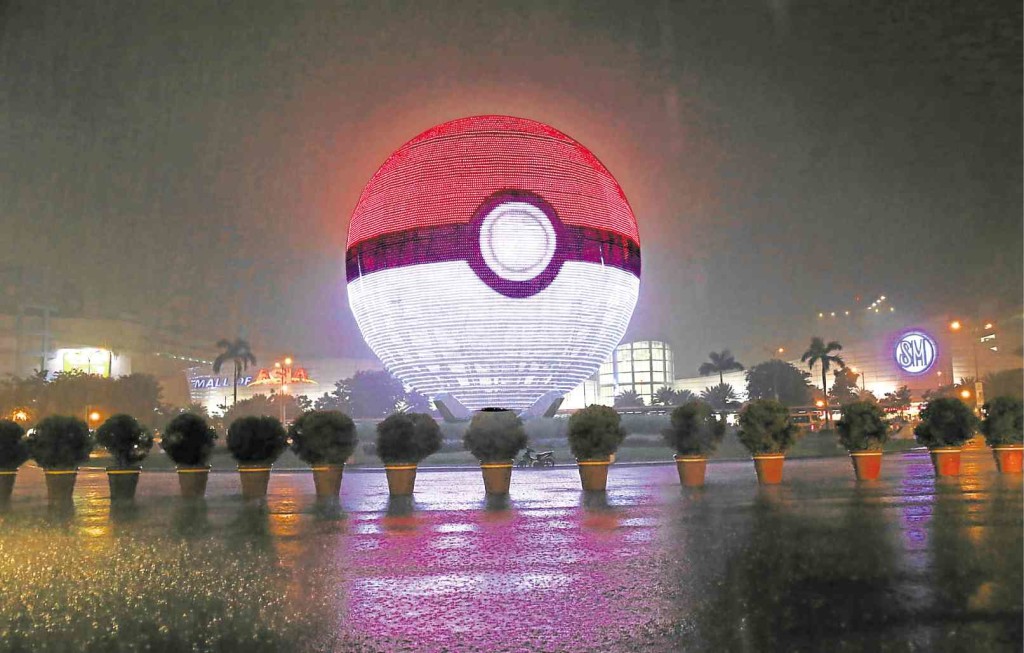HOOKED  The iconic ball of SM Mall of Asia has been transformed into a giant Poke Ball for the reality mobile game Pokemon Go, which has become a worldwide craze. Shopping malls in Metro Manila are hosting a series of “lure parties” to attract more Pokemon players. CONTRIBUTED PHOTO