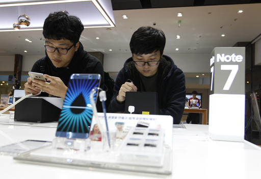 South Korean high school students try out Samsung Electronics Galaxy Note 7 smartphones at the company's shop in Seoul in Seoul, South Korea, Monday, Oct. 10, 2016. Samsung Electronics has temporarily halted production of its Galaxy Note 7 smartphones, South Korea's Yonhap news agency reported Monday, following reports that replacements for the fire-prone phones were also overheating. (AP Photo/Ahn Young-joon)