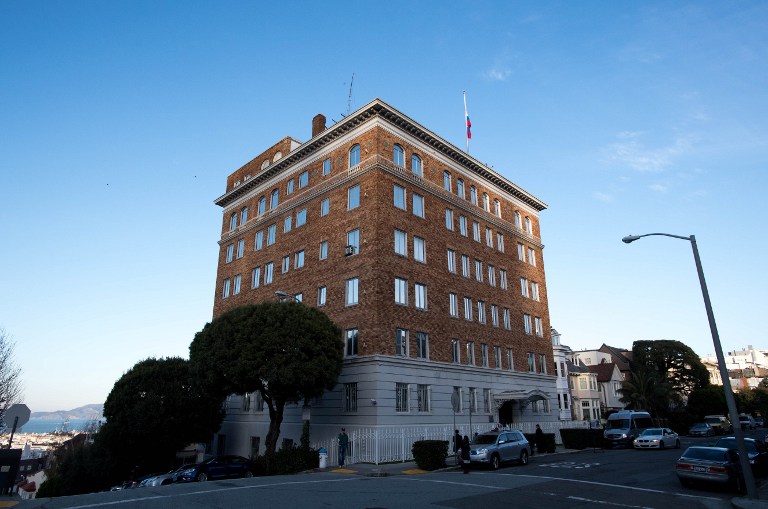People walk past the Consulate-General of Russia in San Francisco, California on December 29, 2016. President Barack Obama unleashed a barrage of retaliatory measures against Moscow for meddling in the US election, imposing sanctions on two intelligence agencies, expelling 35 agents and shuttering two Russian compounds inside the United States in New York and Maryland. The US government said the latter facility, a summer house a short drive from the US capital, is now used "for intelligence-related purposes."  / AFP PHOTO / Josh Edelson