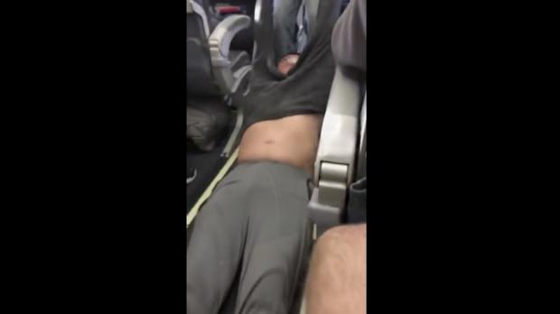 This photo, taken on Sunday, April 9, 2017, made from a video provided by Audra D. Bridges shows a passenger being removed from a United Airlines flight in Chicago. Video of police officers dragging the passenger from an overbooked United Airlines flight sparked an uproar Monday on social media, and a spokesman for the airline insisted that employees had no choice but to contact authorities to remove the man. (Photo by AUDRA D. BRIDGES via AP) 