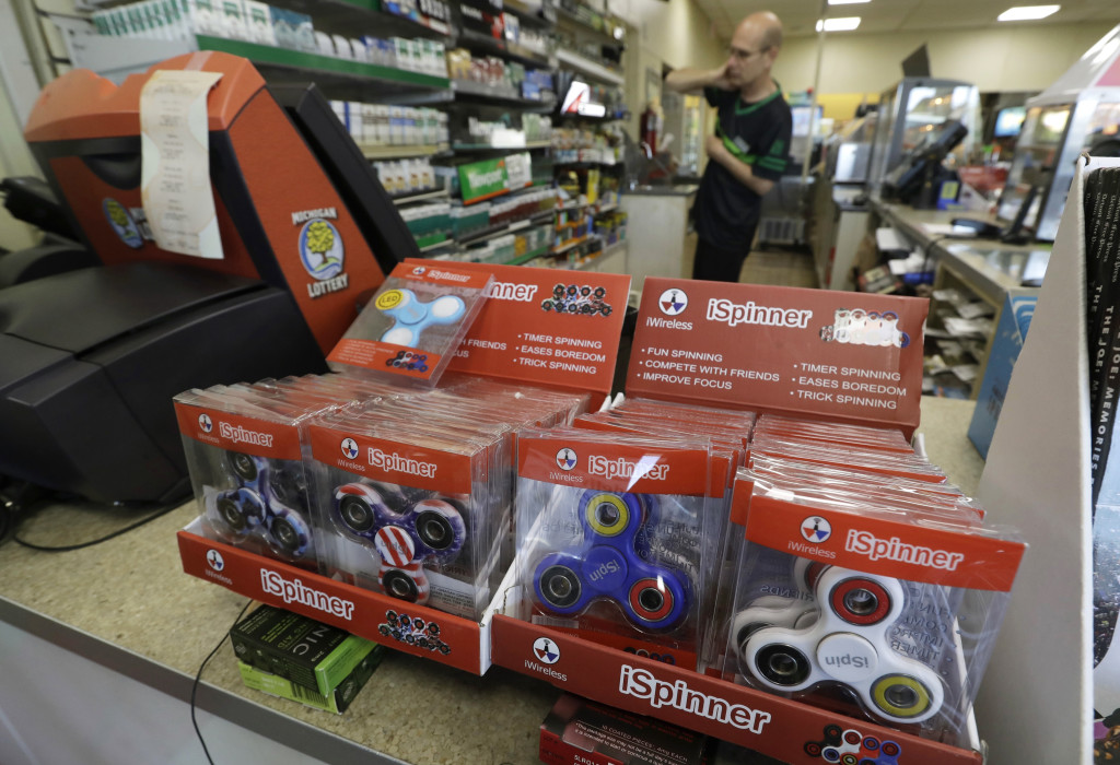 Fidget spinner toys are displayed at a 7-Eleven convenience store, in Warren, Michigan. Stores can’t keep them in stock and parents are going crazy trying to find them. (AP Photo/Carlos Osorio)