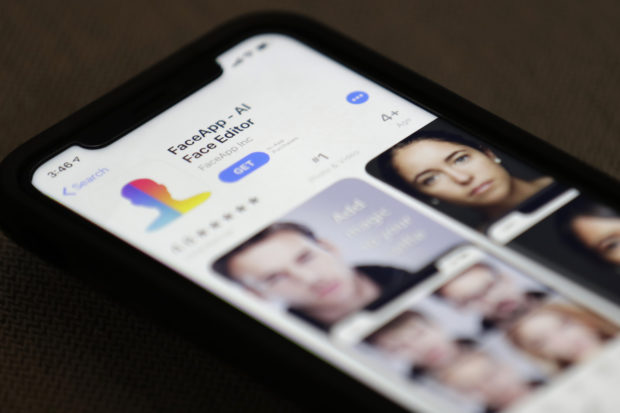 FaceApp is displayed on an iPhone Wednesday, July 17, 2019, in New York. The popular app is under fire for privacy concerns. (AP Photo/Jenny Kane)