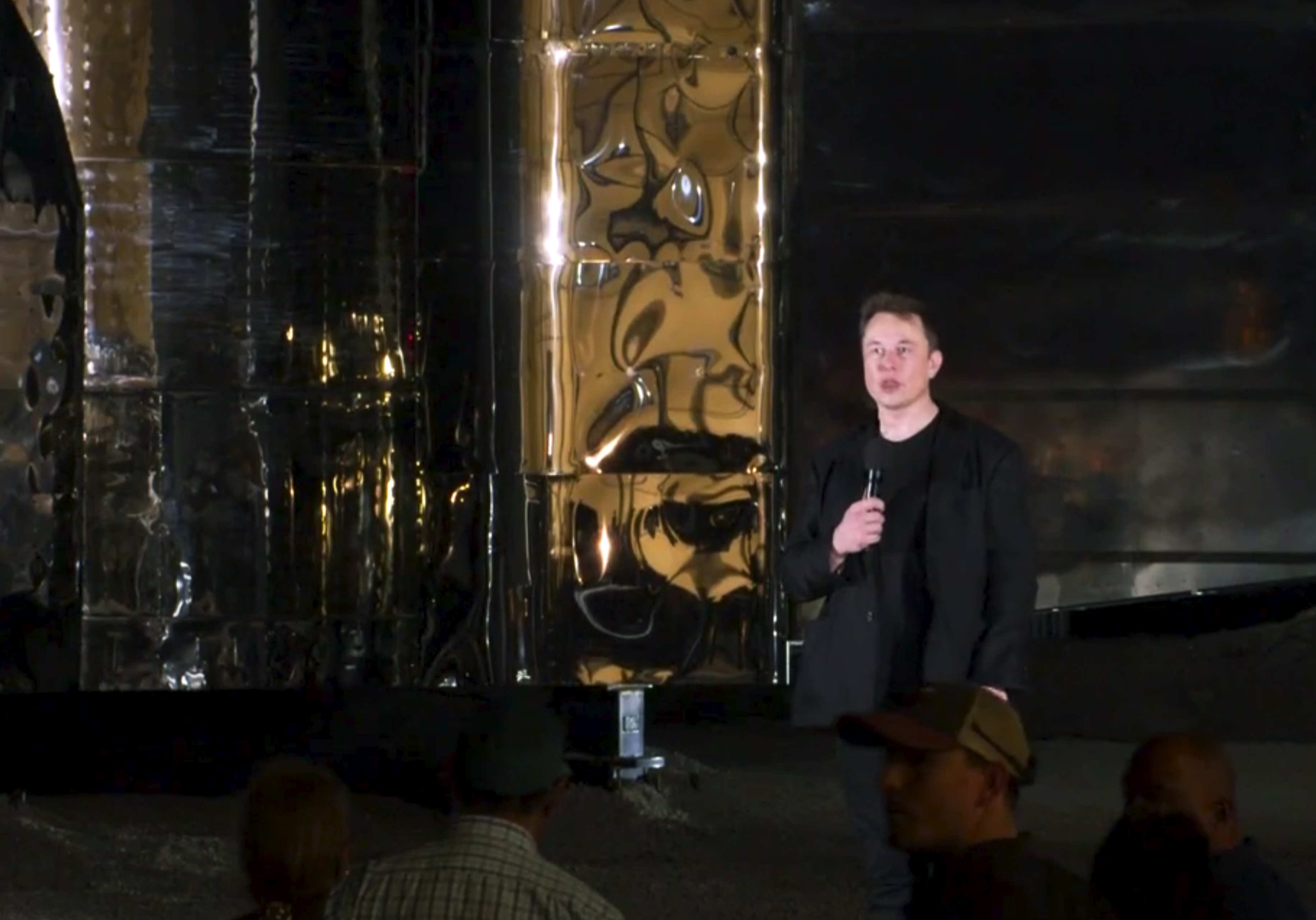 In this image made from video provided by SpaceX, Elon Musk speaks of SpaceX's newly designed aircraft at its launch facility near Brownsville, Texas, Saturday, Sept. 28, 2019. Musk unveiled Saturday the SpaceX spacecraft designed to carry a crew and cargo to the moon, Mars or anywhere else in the solar system and land back on Earth perpendicularly. (SpaceX via AP)