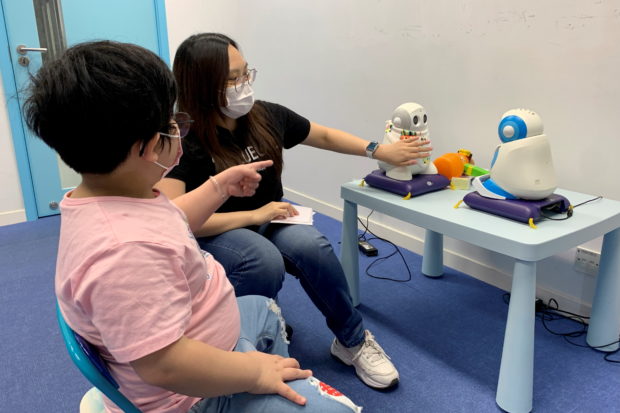 FILE PHOTO: Autism tutor Sarah Ng uses robots to teach a 5-year-old child with special needs to introduce herself, in Hong Kong, China April 17, 2021. Picture taken April 17, 2021. REUTERS/Yoyo Chow