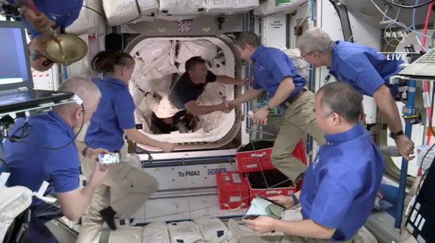 JAXA astronaut Akihiko Hoshide of Japan is welcomed by Crew 1 aboard the International Space Station
