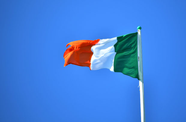 National flag of Ireland flies above the President's residence in Dublin