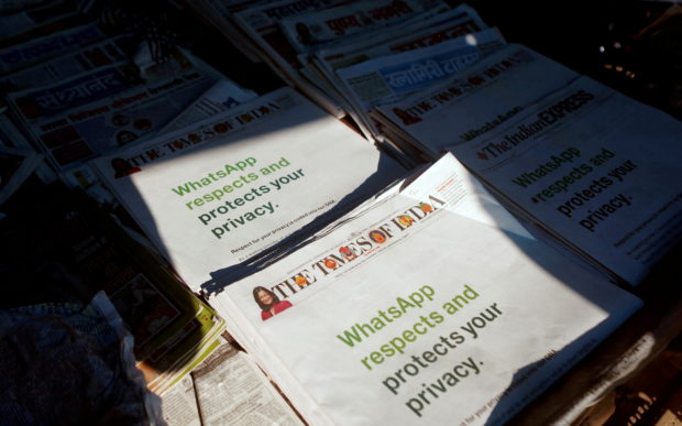 A WhatsApp advertisement is seen on the front pages of newspapers at a stall in Mumbai