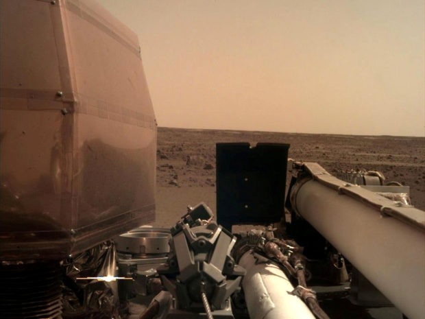 The Instrument Deployment Camera (IDC), located on the robotic arm of NASA's InSight lander, took this image of the Martian surface the day the spacecraft touched down on the Red Planet, and was relayed from InSight to Earth via NASA's Odyssey spacecraft, currently orbiting Mars, on November 26, 2018.    Picture taken November 26, 2018.  