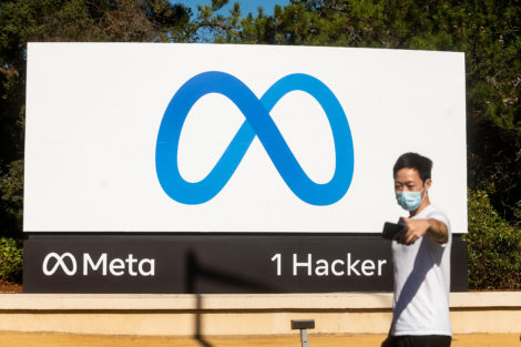 A person takes a selfie in front of a newly unveiled logo for "Meta", the new name for Facebook's parent company, outside Facebook headquarters in Menlo Park on October 28, 2021. - Facebook changed its parent company name to "Meta" on October 28 as the tech giant tries to move past being a scandal-plagued social network to its virtual reality vision for the future. (Photo by NOAH BERGER / AFP)