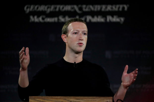 Facebook Chairman and CEO Mark Zuckerberg addresses the audience on "the challenges of protecting free speech while combating hate speech online, fighting misinformation, and political data privacy and security," at a forum hosted by Georgetown University's Institute of Politics and Public Service (GU Politics) and the McCourt School of Public Policy in Washington, U.S., October 17, 2019. REUTERS/Carlos Jasso/File Photo