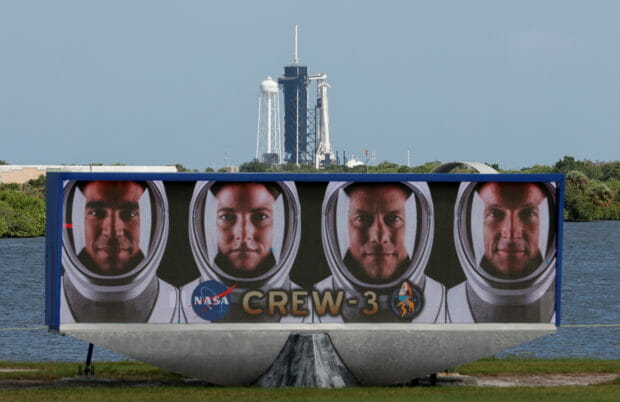 FILE PHOTO: A SpaceX Falcon 9 rocket stands on the launch pad behind the pictures of crew members on the countdown clock, as final preparations are made for the Crew 3 mission to the International Space Station at the Kennedy Space Center in Cape Canaveral. Florida, U.S. October 29, 2021. Launch is scheduled for October 31. REUTERS/Joe Skipper
