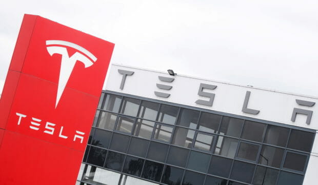 FILE PHOTO: The logo of car manufacturer Tesla is seen at a dealership in London, Britain, May 14, 2021. REUTERS/Matthew Childs/File Photo