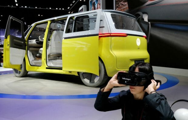 A visitor uses virtual reality device next to Volkswagen's concept ID.Buzz during media preview of the 45th Tokyo Motor Show in Tokyo, Japan October 25, 2017. REUTERS/K