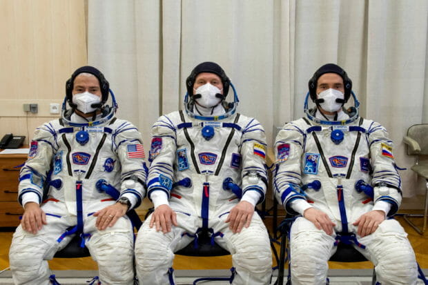 FILE PHOTO: The International Space Station (ISS) crew members Mark Vande Hei of NASA, cosmonauts Oleg Novitskiy and Pyotr Dubrov of Roscosmos are pictured during space suit check at the Baikonur Cosmodrome, Kazakhstan April 9, 2021. Irina Spector/GCTC/Roscosmos/Handout via REUTERS