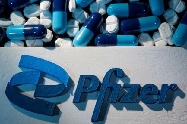 FILE PHOTO: FILE PHOTO: A 3D printed Pfizer logo is placed near medicines from the same manufacturer in this illustration taken September 29, 2021. REUTERS/Dado Ruvic/Illustration/File Photo