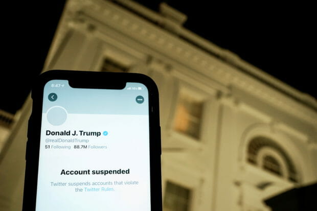 FILE PHOTO: A photo illustration shows the suspended Twitter account of U.S. President Donald Trump on a smartphone and a lit window in the White House residence in Washington, U.S., January 8, 2021.  REUTERS/Joshua Roberts/Illustration/File Photo