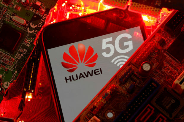 FILE PHOTO: A smartphone with the Huawei and 5G network logo is seen on a PC motherboard in this illustration picture taken January 29, 2020. REUTERS/Dado Ruvic