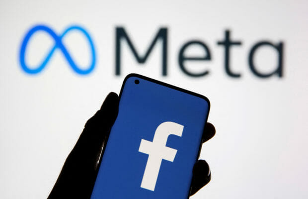 FILE PHOTO: A smartphone with Facebook's logo is seen in front of displayed Facebook's new rebrand logo Meta in this illustration taken October 28, 2021. REUTERS/Dado Ruvic/Illustration/