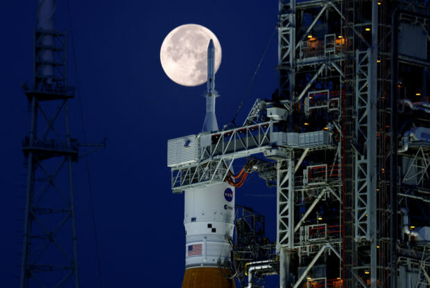 A full moon, known as the "Strawberry Moon" is shown with NASA’s next-generation moon rocket, the Space Launch System (SLS) Artemis 1, at the Kennedy Space Center in Cape Canaveral, Florida, U.S. June 15, 2022. REUTERS/Joe Skipper/File Photo
