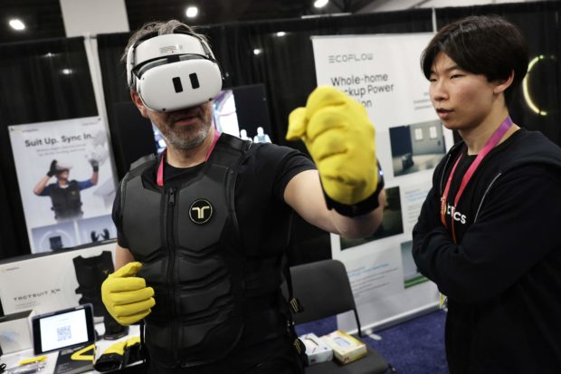 A man tries out a gaming suit at the three-day CES tech show in Las Vegas. STORY: Tech show gives gamers that sensation of reality