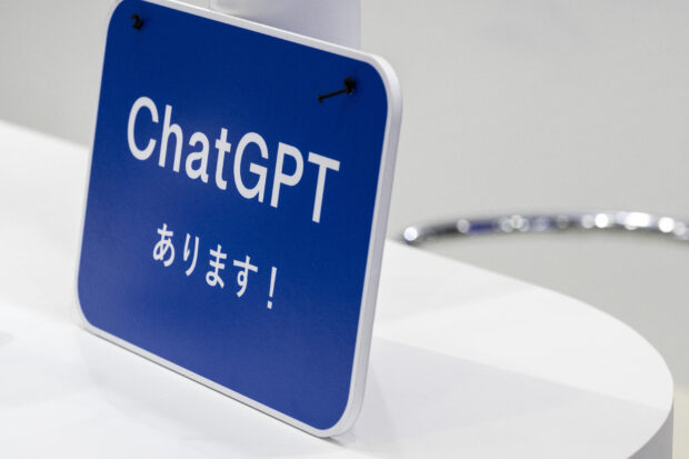 A sign promoting ChatGPT, a hugely popular language app that has sparked a rush in artificial intelligence technology, is displayed at a booth during the three-day 7th AI Expo, part of NexTech Week Tokyo 2023, Japan's largest trade show for artificial intelligence technology companies, at Tokyo Big Sight on May 10, 2023. (Photo by Richard A. Brooks / AFP)