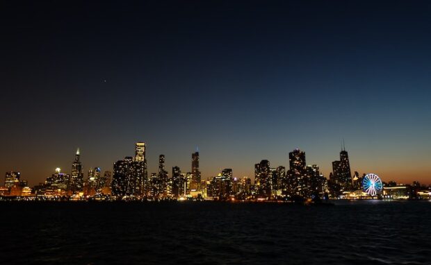 Image showing a city with glaring lights obscuring the night sky.